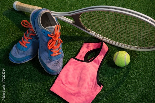Sports shoes with tennis ball and racket by sports bra
