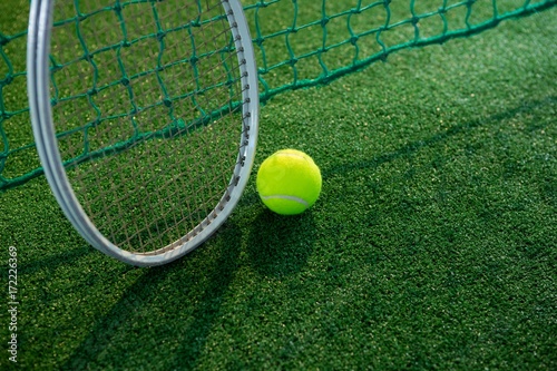 High angle view of tennis ball with racket by net