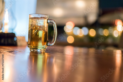 blurred glass of beer in bar background