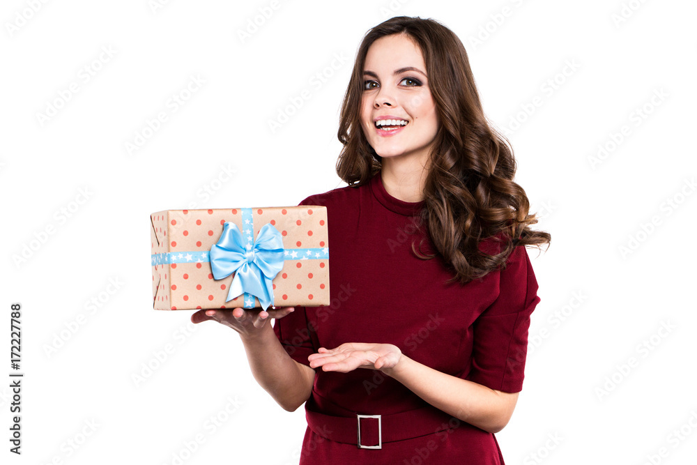 Portrait of a smiling cute woman with gift box and looking at camera isolated on a white background. Portrait of a smiling cute woman with gift box and looking at camera isolated on a white background.