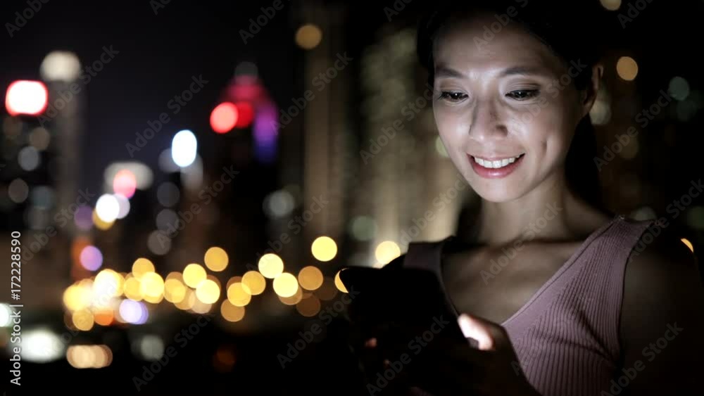 Asian Woman using smart phone in the city Asian Woman using smart phone in the city