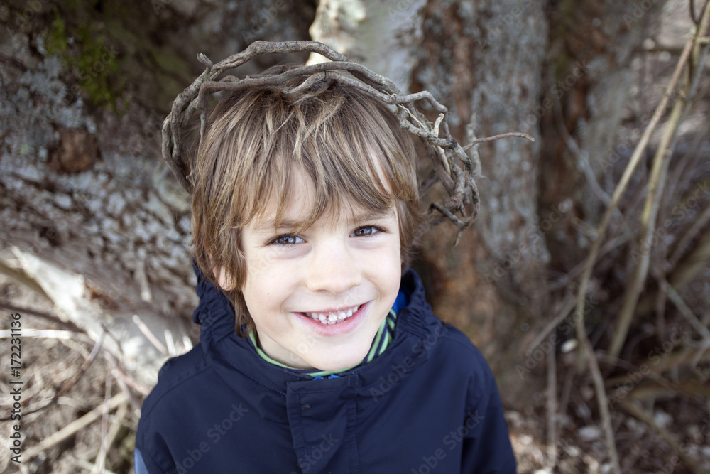 Boy wearing a crown of sticks Boy wearing a crown of sticks