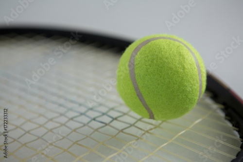 Close up of fluorescent tennis ball on racket © WavebreakMediaMicro