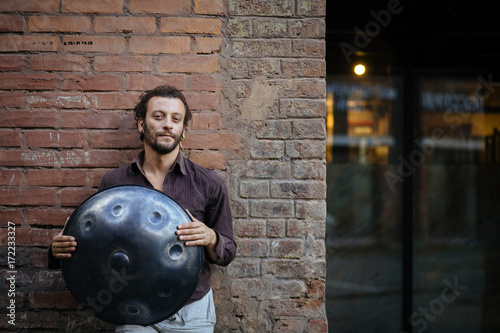 Musician with hang drum