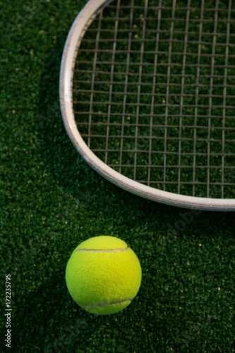 Cropped image of racket by tennis ball