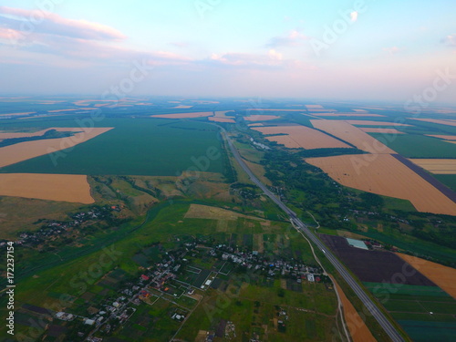 Aerial view of beautiful village, houses, roads. Sky, clouds.