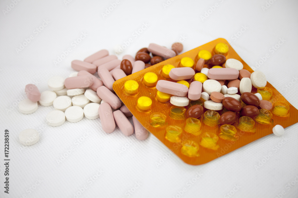 Colorful pills laying on the white background Colorful pills laying on the white background