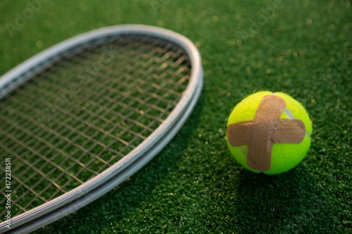 Close up of tennis ball with bandage by racket © WavebreakMediaMicro