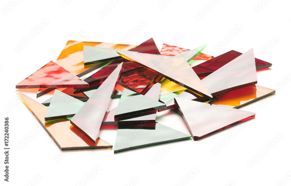 Fototapeta premium Colorful pile of stained glass pieces on a white background. Glass recycling concept