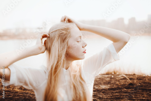 Young blond girl enjoying spring wind