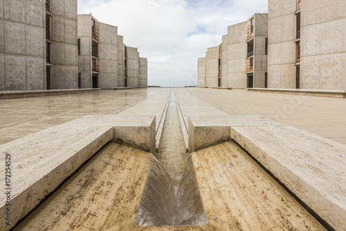 Symmetrical architecture of the Salk Institute in San Diego with fountain vanishing point