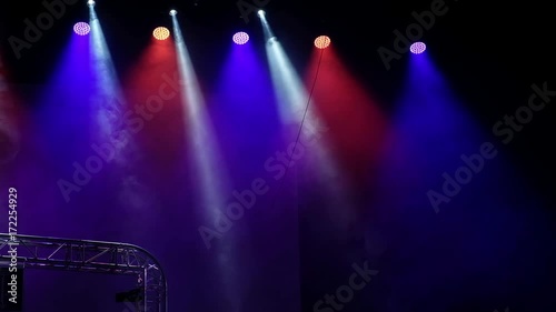 Beautiful dynamic red and blue lighting of the stage with smoke effects photo