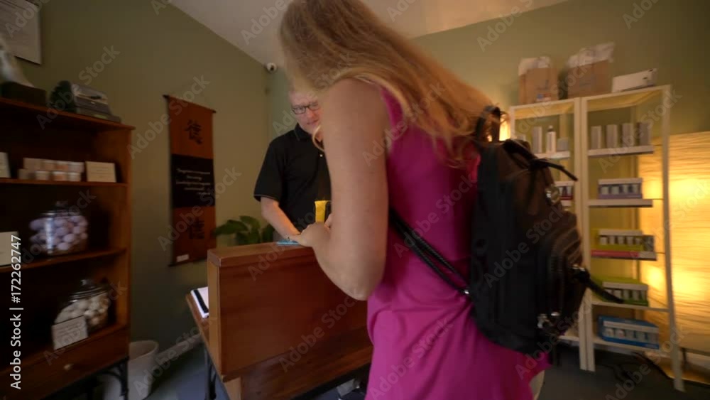 Beautiful woman enters a stylish spa for massage and sugar scrub. Steadicam shot. Beautiful woman enters a stylish spa for massage and sugar scrub. Steadicam shot.