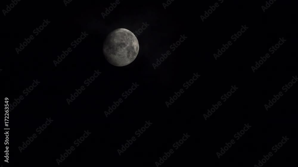 Full moon at night on dark black sky behind moving clouds, moonlight 4K ProRes HQ codec Full moon at night on dark black sky behind moving clouds, moonlight 4K ProRes HQ codec