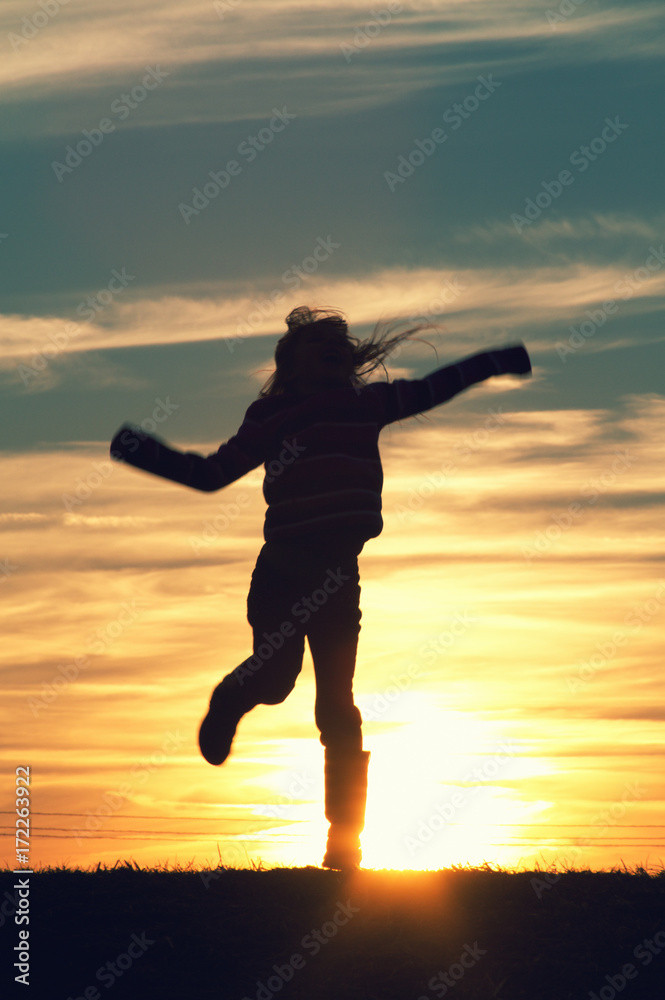 a child jumping at sunset. a child jumping at sunset.