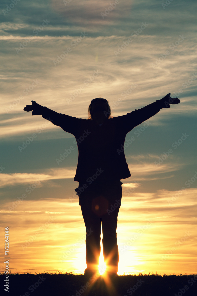 Woman raising her arms in joy Woman raising her arms in joy