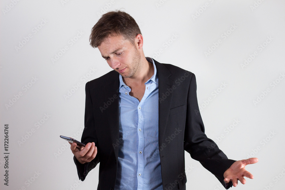Young businessman annoyed with a text Young businessman annoyed with a text