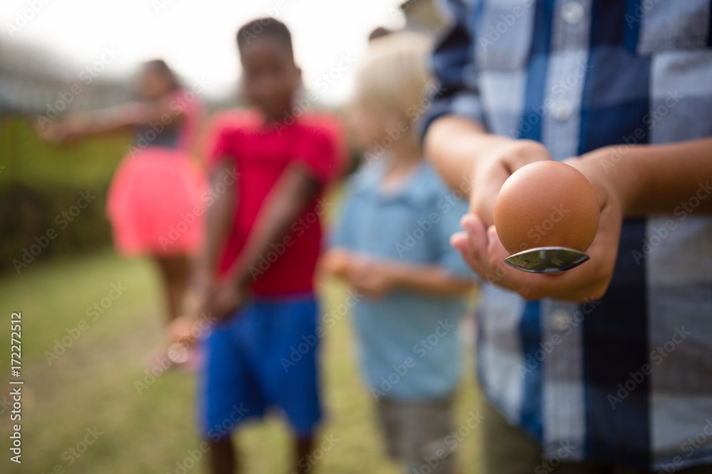 Children playing egg and spoon race