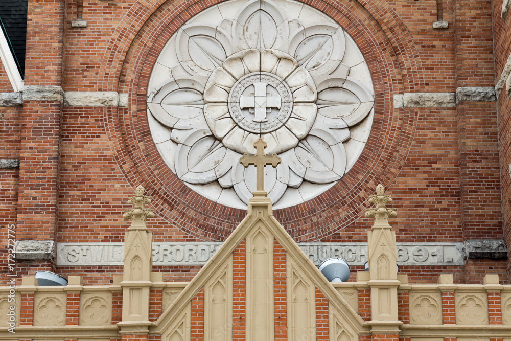 Cross, circle and floral details on St Willebrord Catholic Church in Green Bay, WI - obrazy, fototapety, plakaty 