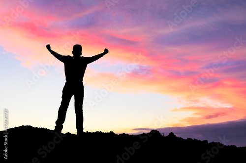 Silhouette of the man success on the peak of mountain,Sport and active life sunset landscape