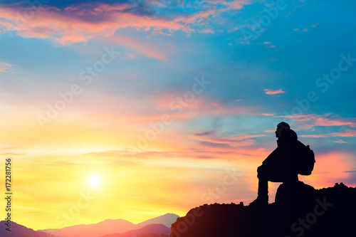 Silhouette of a man on the mountain at sunset