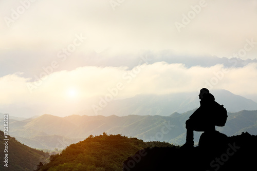Silhouette of a man on the mountain at sunset