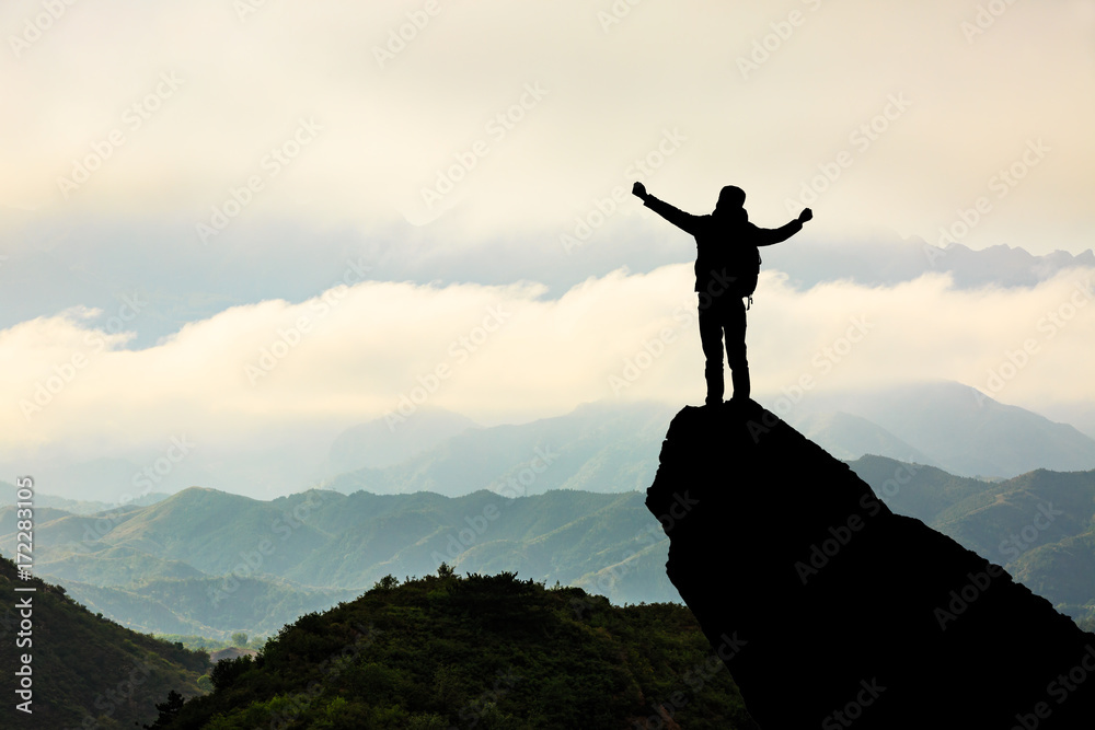 Silhouette of the man success on the peak of mountain,Sport and active life