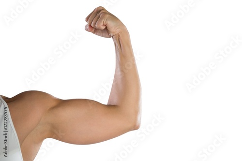 Fototapet Cropped image of sportswoman flexing muscles