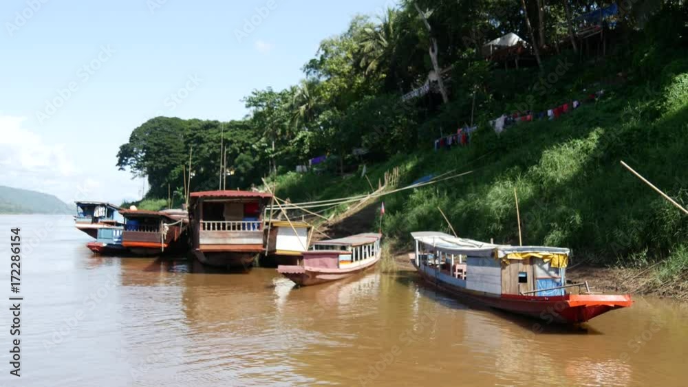 Long-tail boats at the shore in Luang Prabang, Laos Long-tail boats at the shore in Luang Prabang, Laos