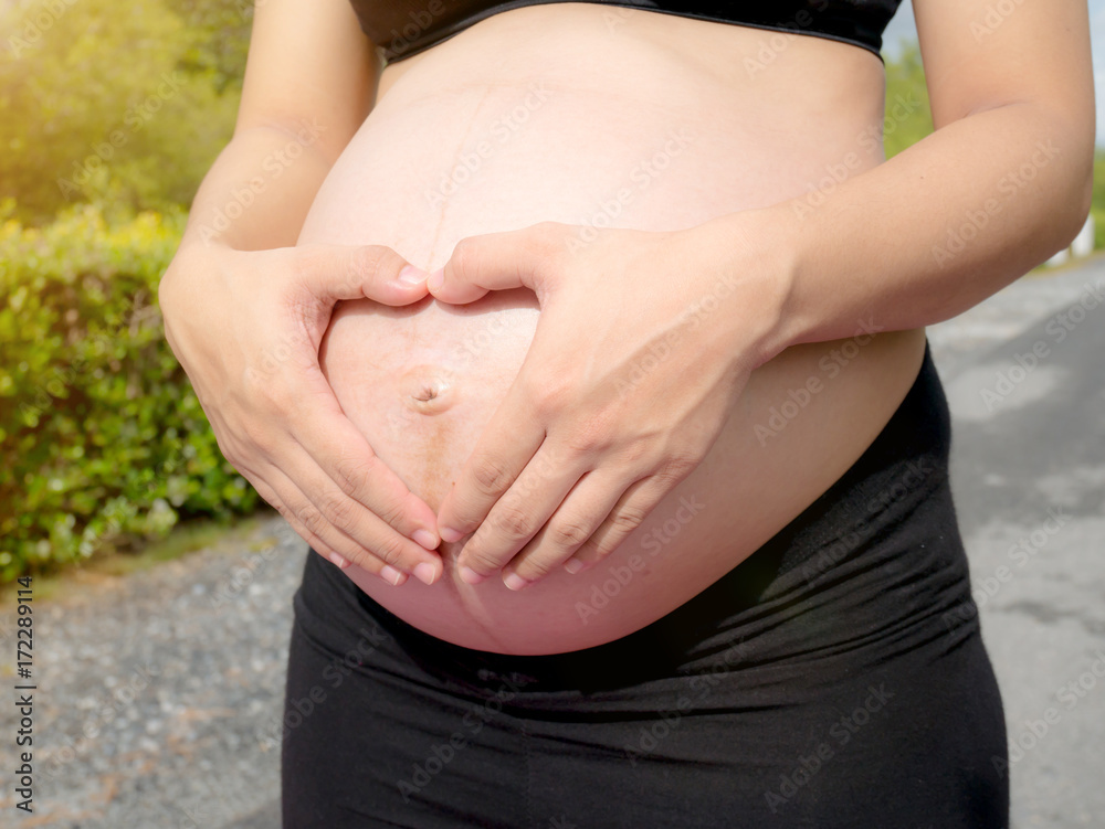 Pregnant woman exercising in the park Pregnant woman exercising in the park
