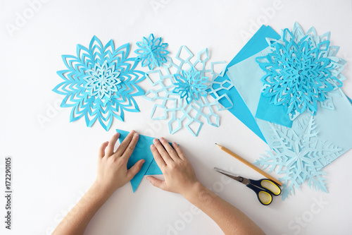 Making of snowflakes from paper. A traditional Christmas arts and crafts project