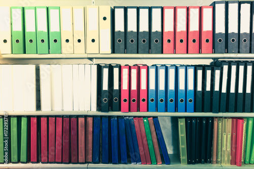 Color folders standing on shelfs