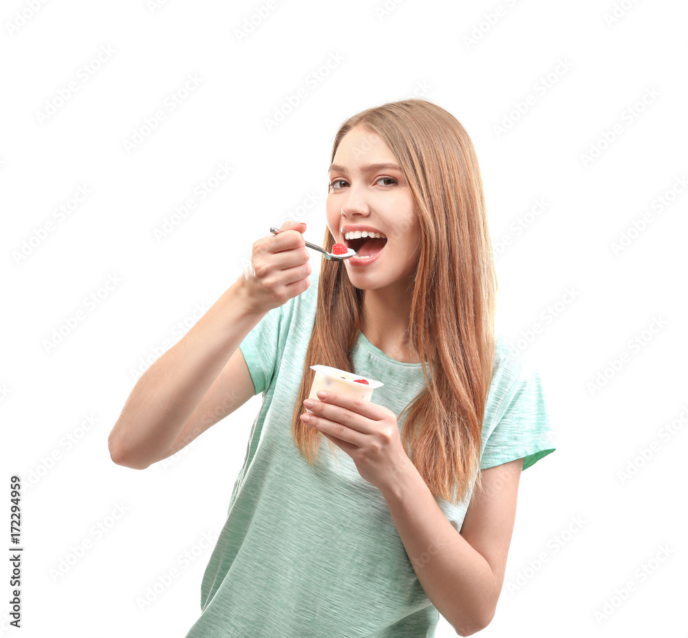 Young woman eating yogurt on white background Young woman eating yogurt on white background