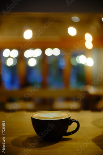 Cup of coffee with bokeh of light and blurry background