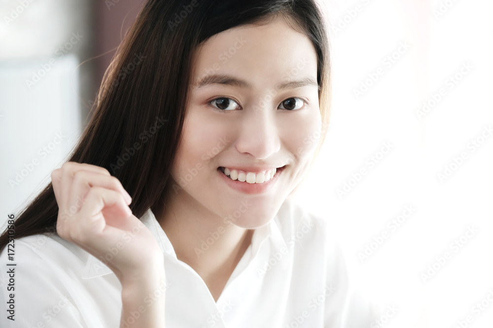 Portrait of smiling asian woman in white shirt and long hair, close up Portrait of smiling asian woman in white shirt and long hair, close up