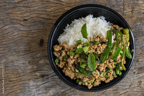 stir fried minced pork with basil with jasmine rice in bowl. thai popular street food