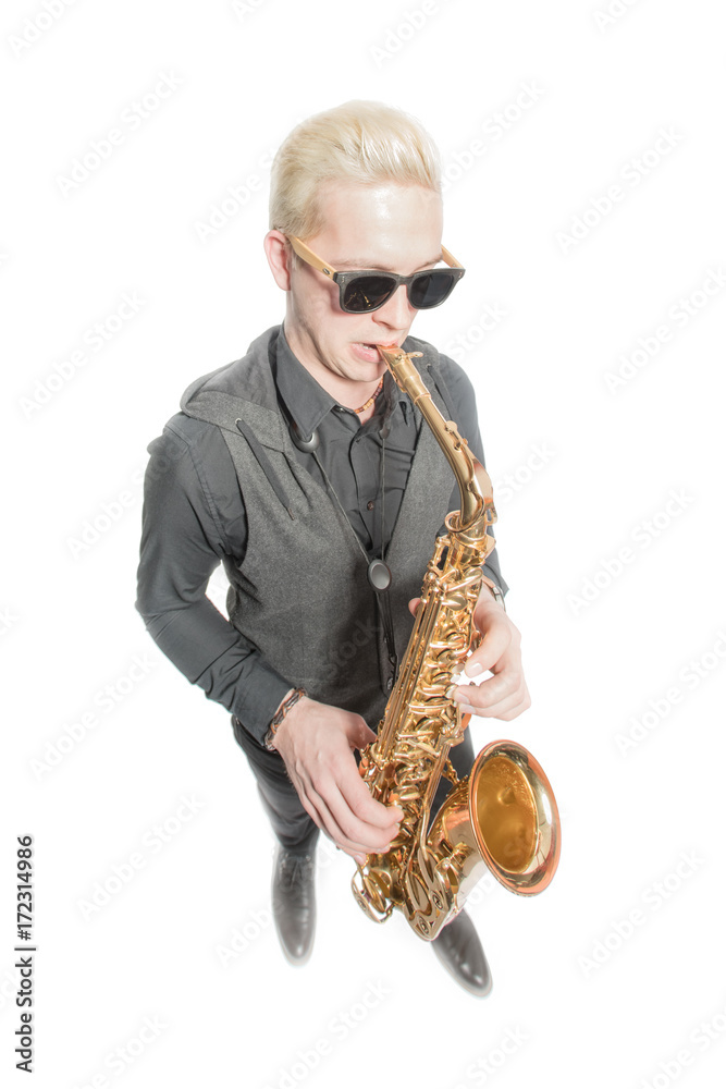 Fototapeta premium Elegant blond man dressed in black, playing the saxophone. Isolated