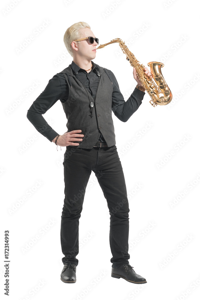 Fototapeta premium Elegant blond man dressed in black, playing the saxophone. Isolated
