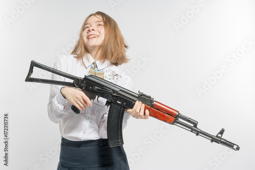 Girl smiling with Kalashnikov in hand. Isolated