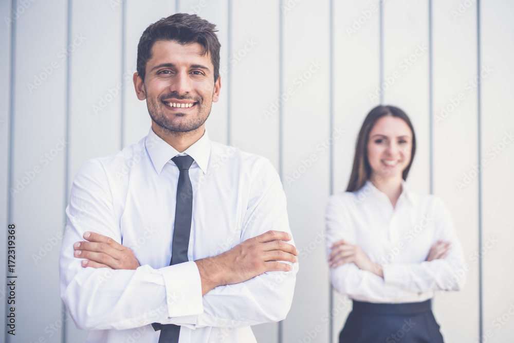 The happy man and woman stand in the office The happy man and woman stand in the office