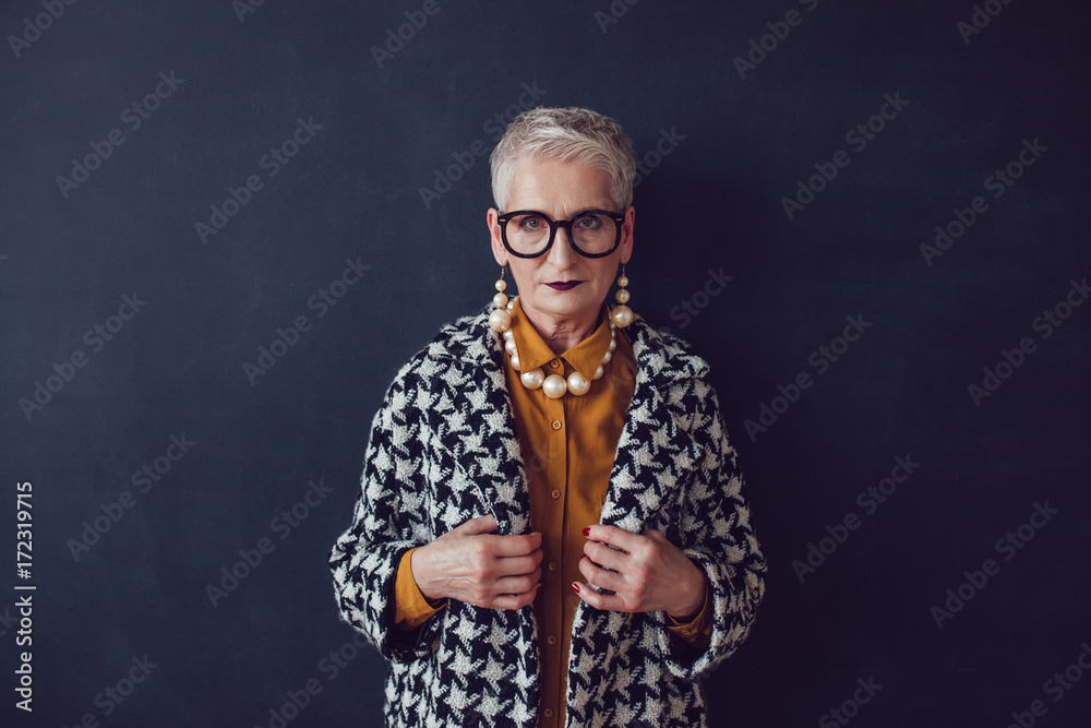 Stylish mature woman in glasses and houndstooth coat - obrazy, fototapety, plakaty 