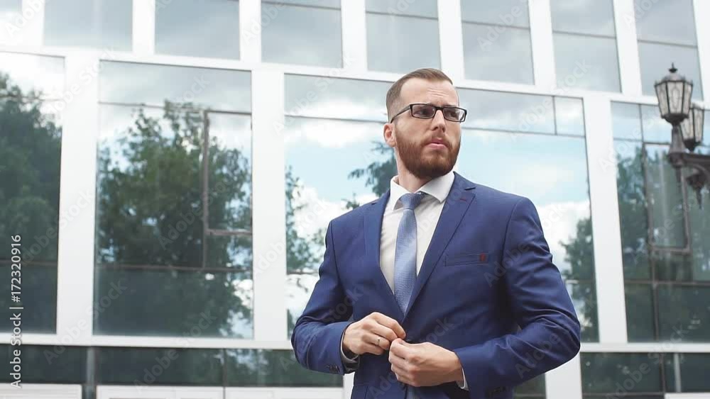 Portrait of young businessman wearing glasses. Slow motion Portrait of young businessman wearing glasses. Slow motion