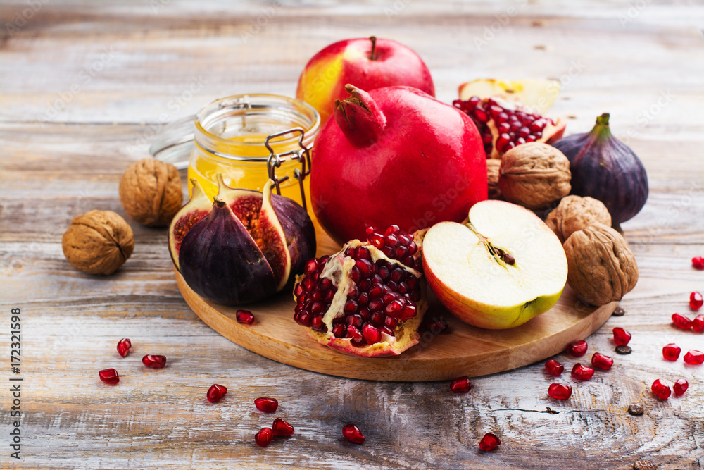 Autumn harvest concept - fruits, wine and nuts on wooden table. Selective focus. Space for text Autumn harvest concept - fruits, wine and nuts on wooden table. Selective focus. Space for text