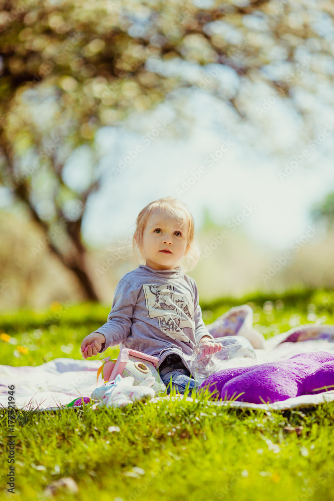 Girl plays in the rays of sun on the lawn Girl plays in the rays of sun on the lawn