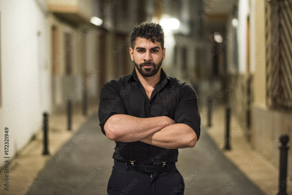 Young man in the night in the middle of the street