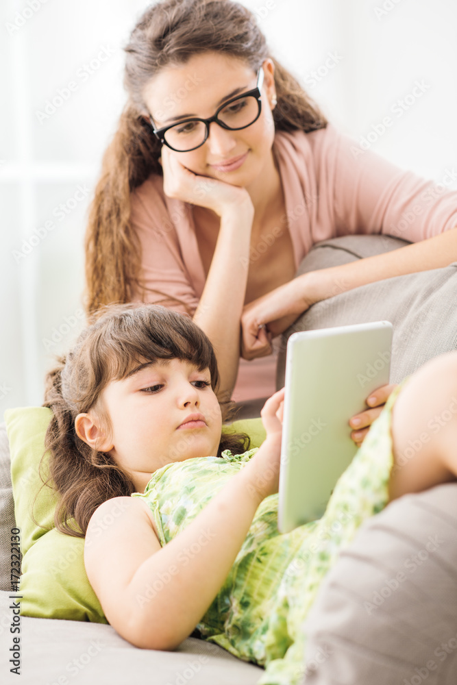 Mother and daughter using a tablet together