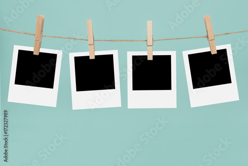 Clothesline with empty  picture frames and clothespins on a blue background