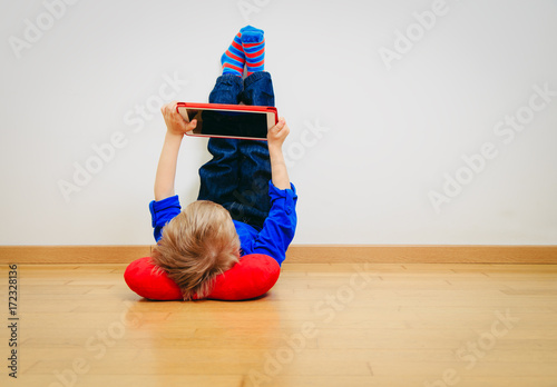 little boy looking at touch pad, home learning