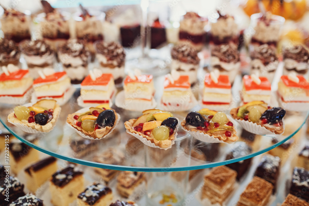 Delicious fancy cakes made of chocolate and cheese stand on the table