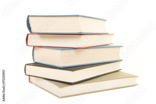 Staple of five books seen from the front isolated on a white background